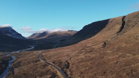 glencoe valley with winding road and river, scottish highlands, serene landscape, aerial view