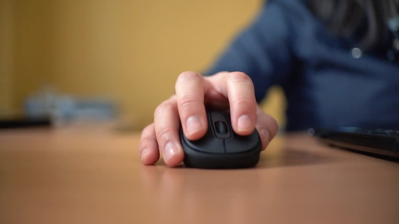 mujer usando una computadora portátil en casa haciendo clic con el mouse