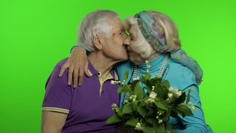 Mature-senior-old-couple.-Grandfather-gives-bouquet-of-flowers-to-grandmother