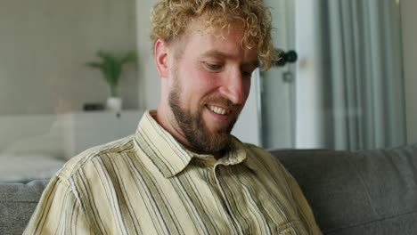 man using credit card on couch