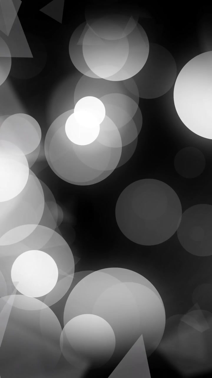 Animation of glowing light spots and triangles moving over black background