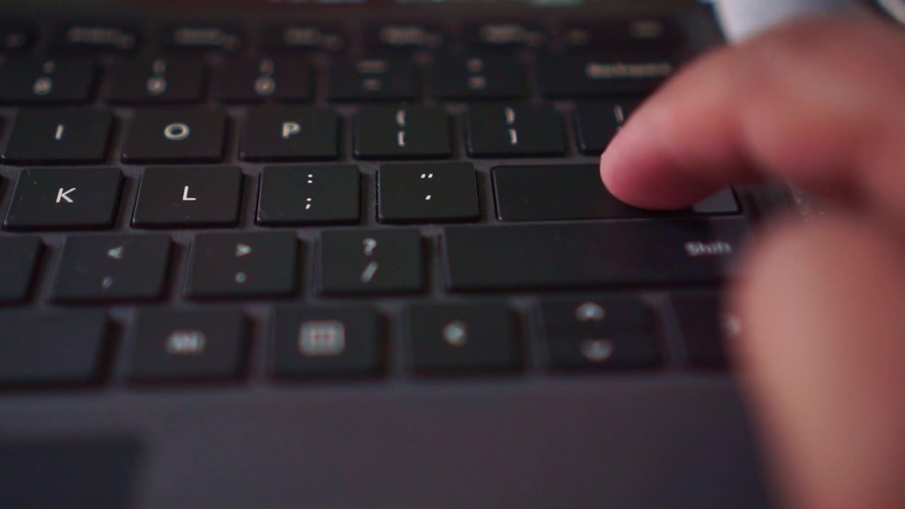 Typing action on a laptop keyboard on "Enter" button, ideal for digital lifestyle, remote work, and internet activity concepts.