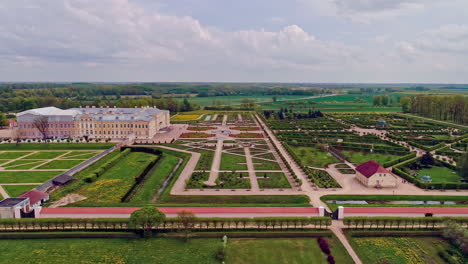 aerial view of beautiful palace castle with large majestic garden during daytime - parking cars of visitor visiting rundale palace in latvia