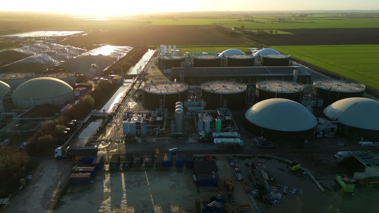High-altitude aerial shot of an anaerobic digestion facility, highlighting the geometric layout of storage domes and energy infrastructure