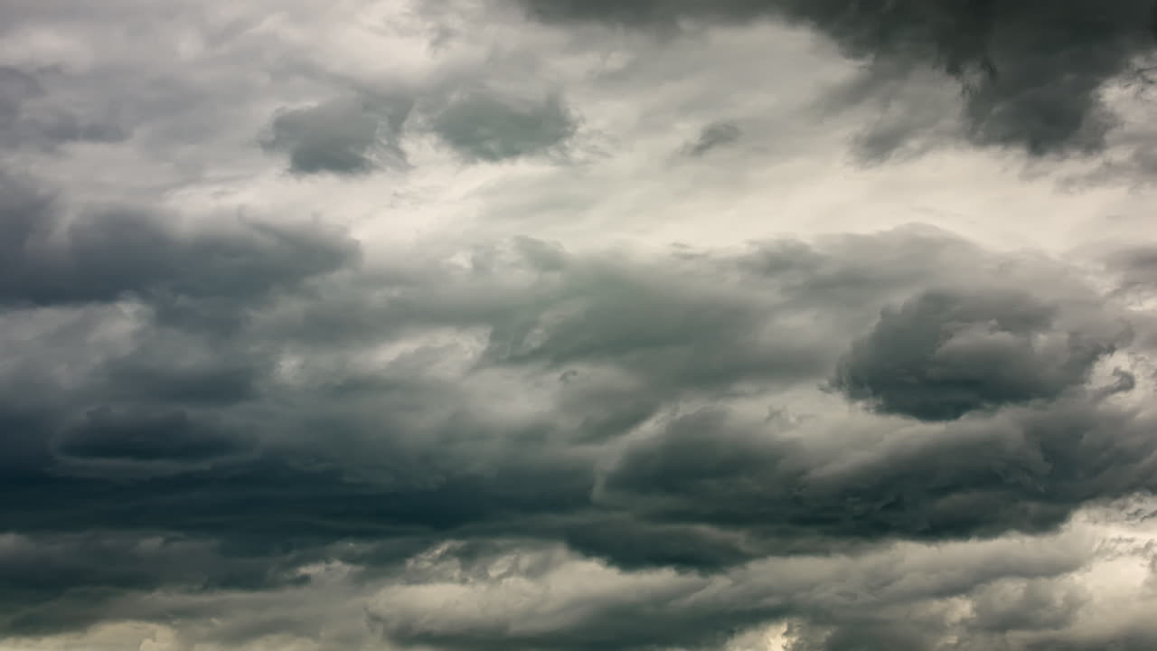 Timelapse of dark storm clouds rushing across the sky with intense movement