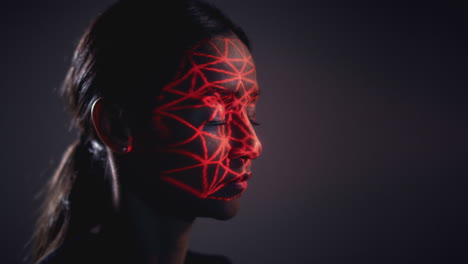 Facial-Recognition-Technology-Concept-As-Woman-Has-Red-Grid-Projected-Onto-Face-In-Studio