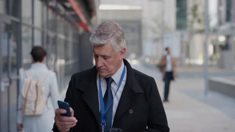 portrait-professional-senior-businessman-using-smartphone-in-city-checking-messages-texting-on-mobile-phone-drinking-coffee-enjoying-relaxed-urban-lifestyle-slow-motion