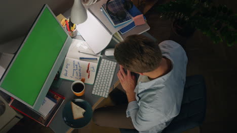 anonymous freelancer writing notes top view. guy texting green screen keyboard