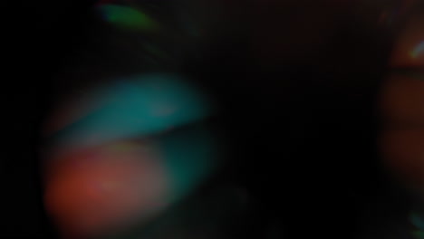 flashing lights with orange and teal color on black background