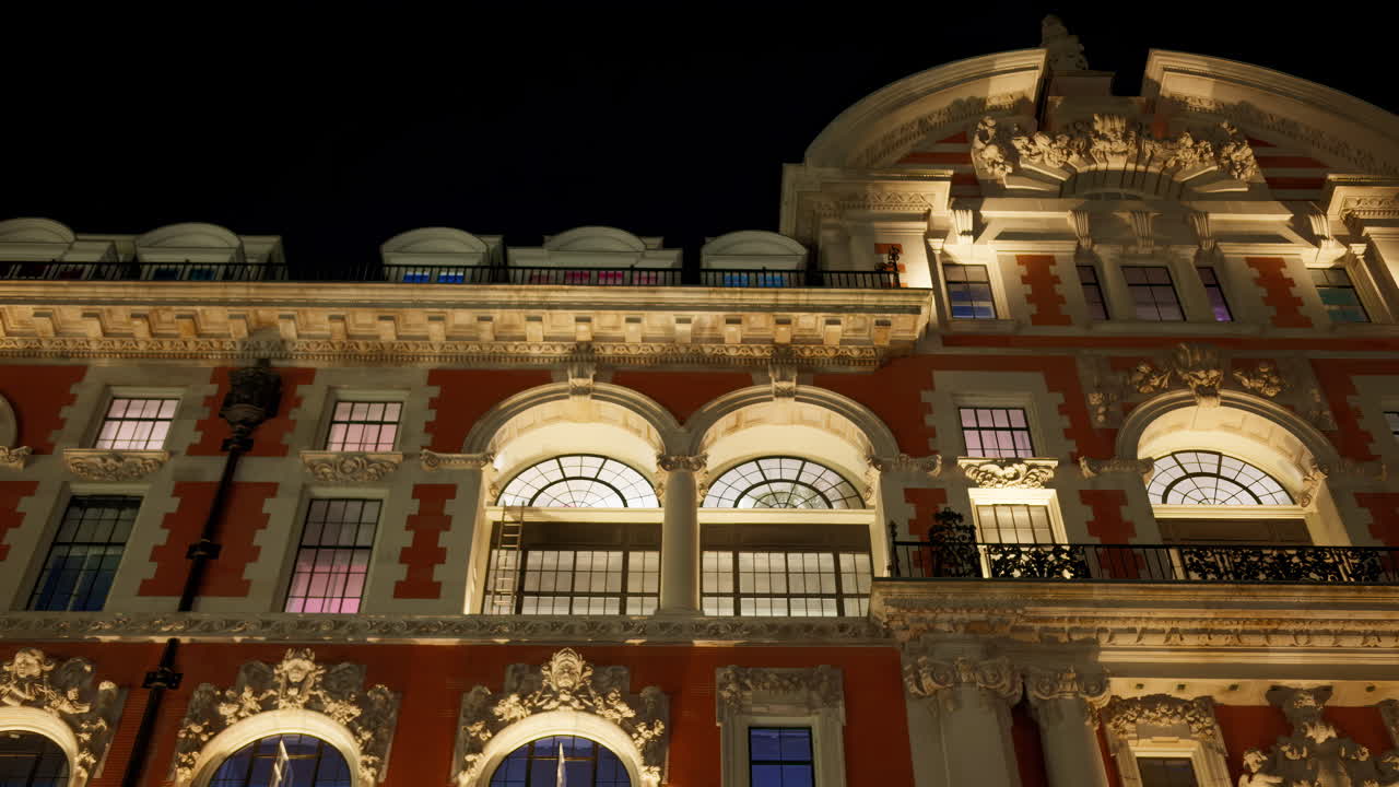 Low-angle view of a grand historical building in London, England with cloudy skies in the background in the evening