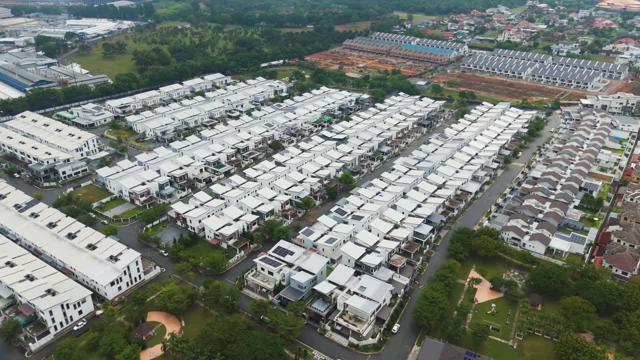 Modern residential housing development on the outskirts of Melaka, Malaysia, captured in UHD with rows of white-roofed homes and greenery