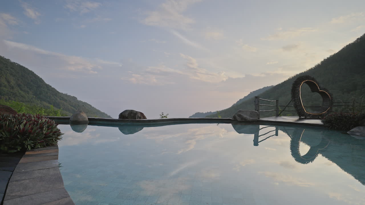 luxury swimming pool set in lush countryside of palm trees