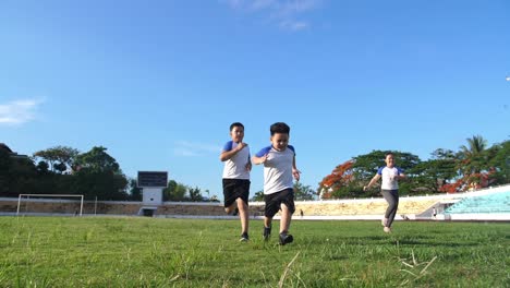happy children running at stadium
