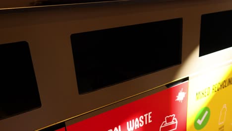 person disposing of waste in a bin