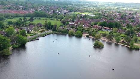 aerial panning down petersfield heath pond sunny day uk 4k