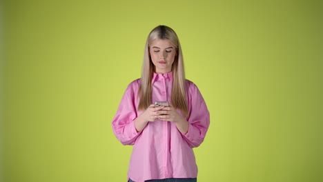 millennial, gen z woman stares at smartphone, typing and smiling, studio shot