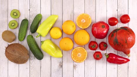 red, orange, yellow and green fruits and vegetables move on wooden theme. stop motion