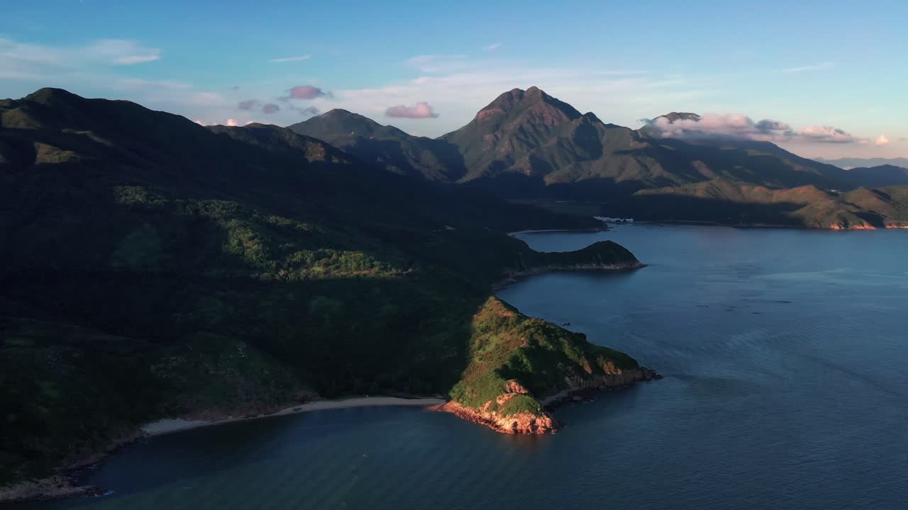 Aerial view of lush tropical mountains at Lantau island. Drone view of beautiful coastline surrounded by mountains in Lantau Island, Hong Kong.