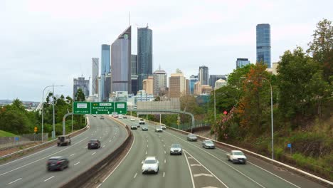 time-lapse shot capturing views of traffic flow on m3 inner city bypass pacific motorway from vulture street with brisbane urban cityscape on the skyline.