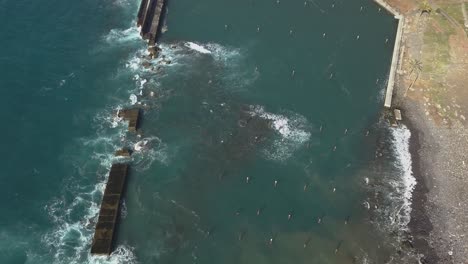 aerial view of the waves destruction on the deactivated marina of lugar de baixo, ponta do sol, madeira ísland, portugal