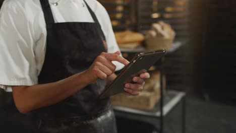 Animation-of-hands-of-asian-female-baker-using-tablet