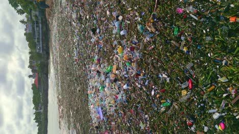 Vertical-video-of-marine-debris-floating-on-Playa-Montesinos-coastline