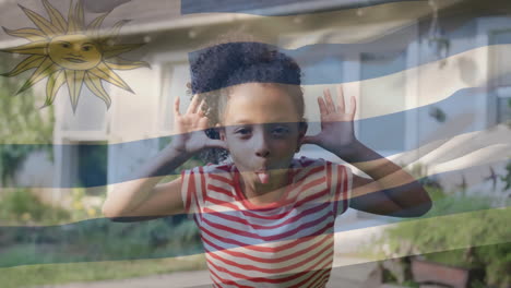 animation of flag of uruguay over biracial girl making face