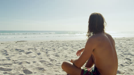 man relaxing on the beach 4k