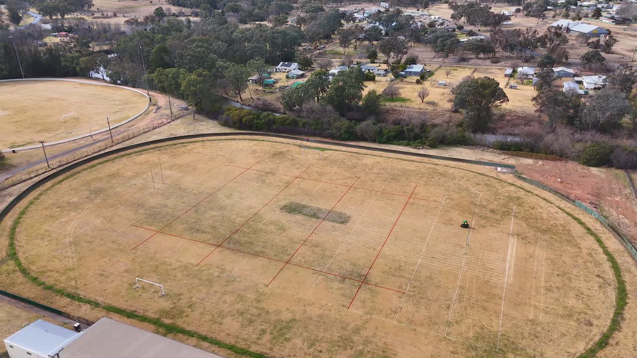 Drone footage over local sports oval in residential neighborhood