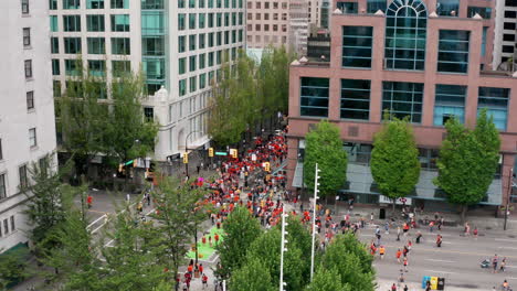 protesters walk in a busy downtown urban area, drone view from above in uhd