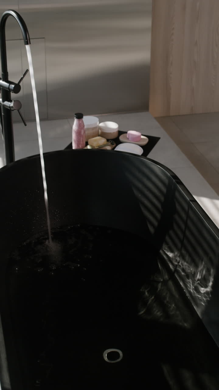 Modern Black Bathtub Filling with Water