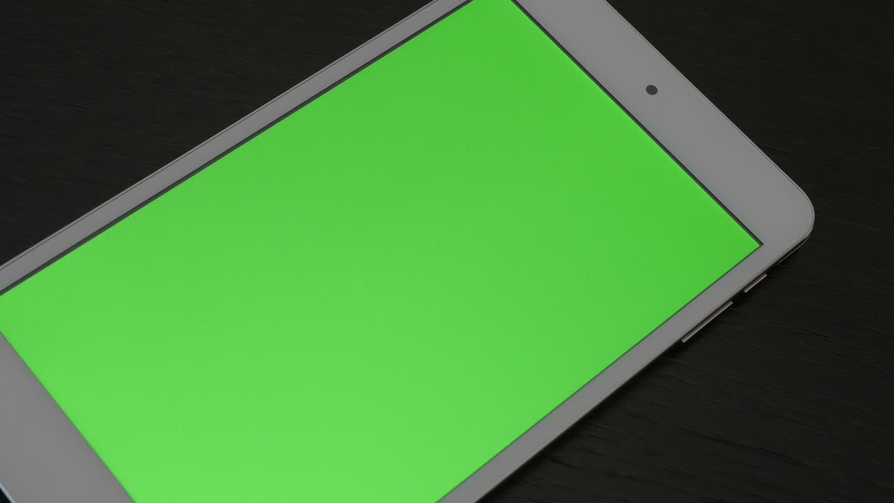 Silver tablet with greenscreen display on wooden surface slow panning 4K 3840X2160 UHD footage - Panning over PC tablet with green screen display on table 4K 2160p UHD video