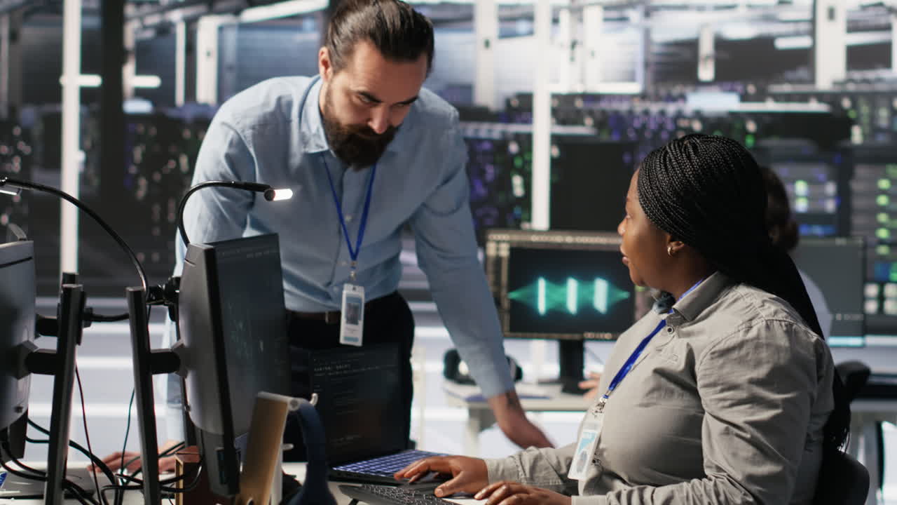 Vertical video Server room manager providing feedback to employee managing AI datasets