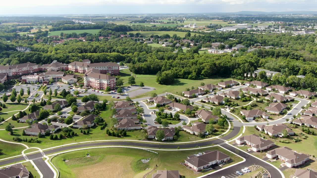 High wide aerial pan shot of retirement home community in United States, CCRC, residential independent living and assisted living nursing home, old peoples home, retirement theme