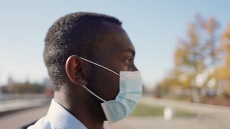 man wearing mask walking outside