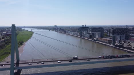 Aerial-view,-futuristic-modern-crane-shaped-buildings,-Cologne-city-riverfront