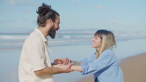 happy caucasian couple having fun at the beach