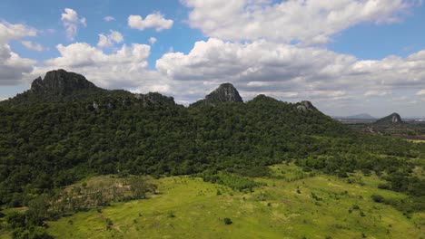 an aerial drone footage of hillside with trees and rocks in lopburi province, thailand