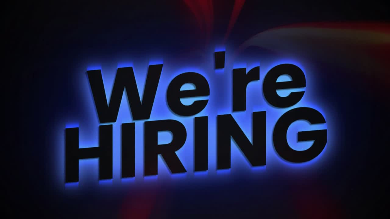 Red and orange streaks flashing glowing letters emerging forming We're HIRING announcing hiring