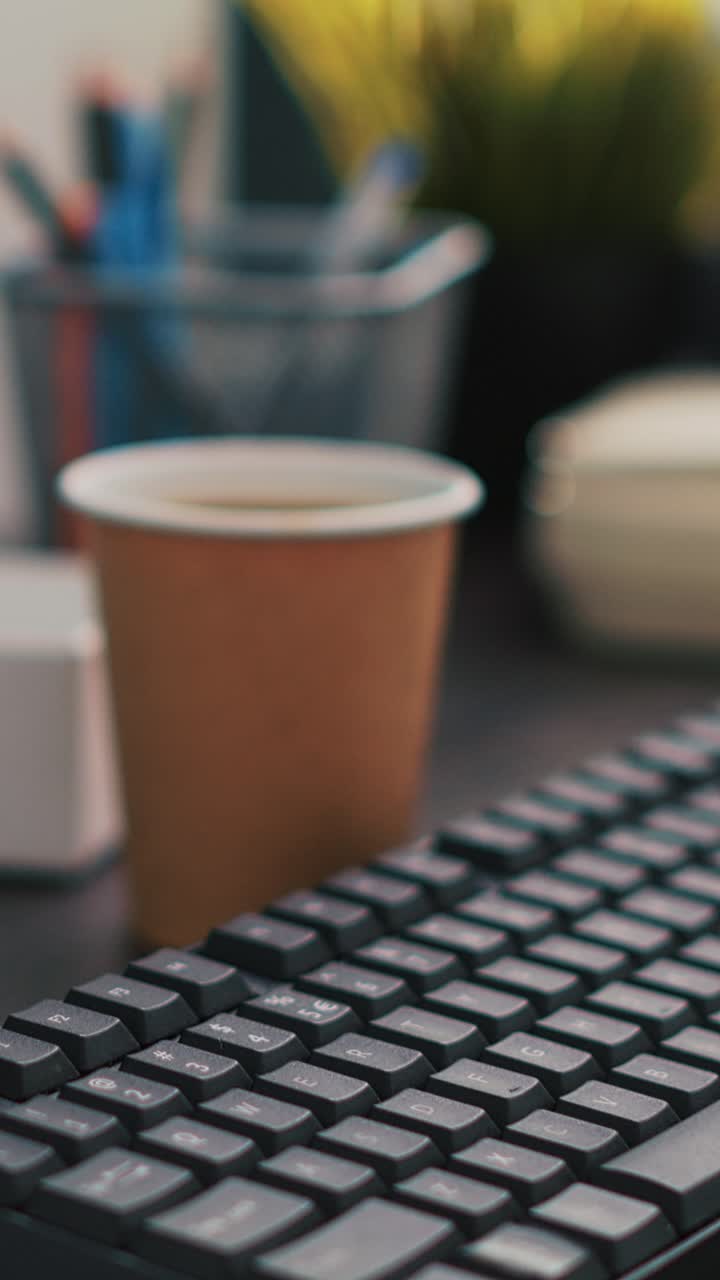 Vertical video Company files and coffee on table in accounting office, close up
