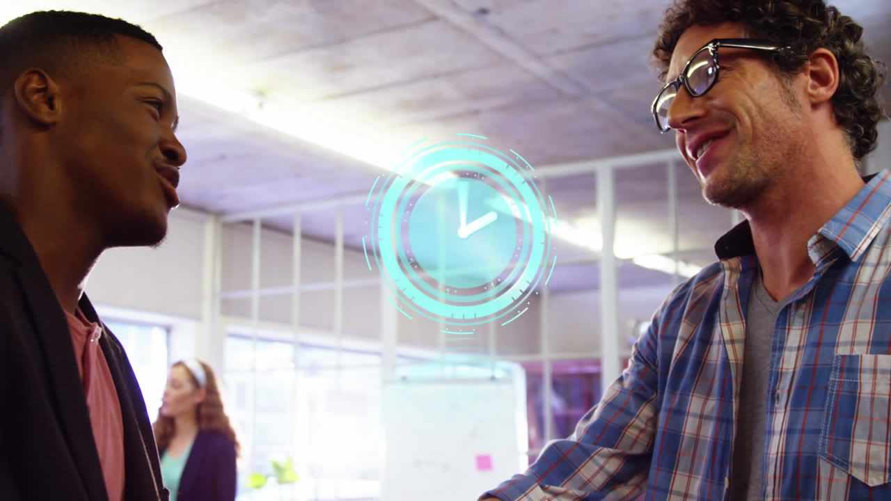 Animation of clock over diverse male business colleagues shaking hands
