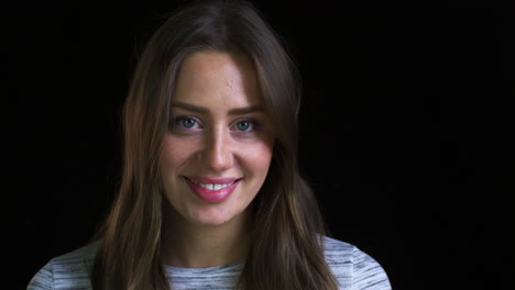 Close-Up-Of-Attractive-Young-Woman-Laughing-Into-Camera