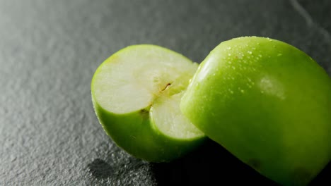 halved green apple on concrete background 4k 4k