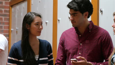 students on their smartphone leaning on lockers