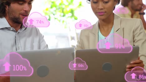 Animation-of-cloud-icons-with-increasing-percentage-over-diverse-man-and-woman-discussing-at-office