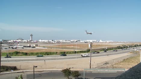 a wide shot of planes take off and taxi at los angeles international airport