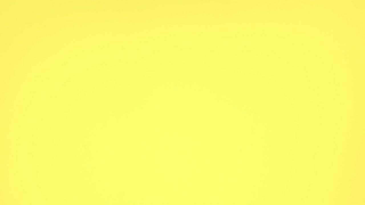 Birthday party decorations and food for party appear on yellow background - Stop motion