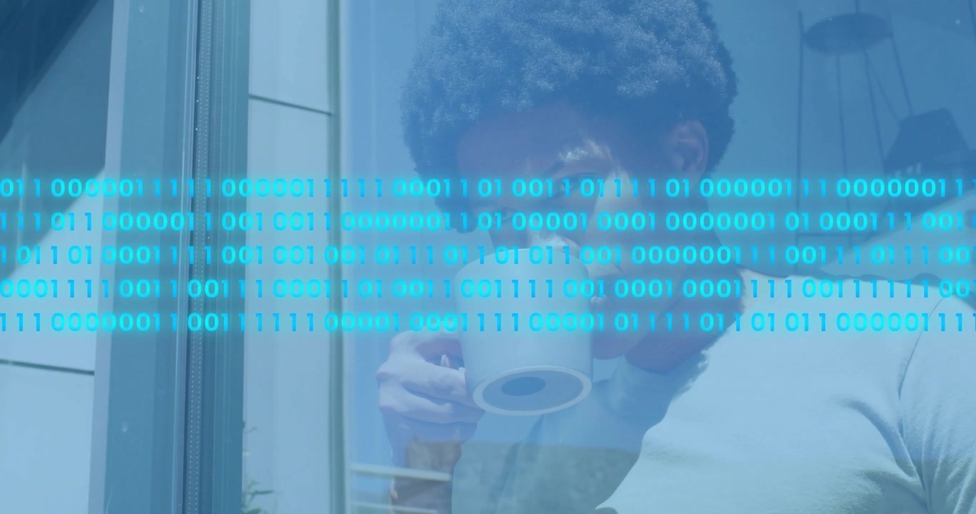 Adult man sipping mug beside patio glass door, binary code fading in then scrolling while smiling