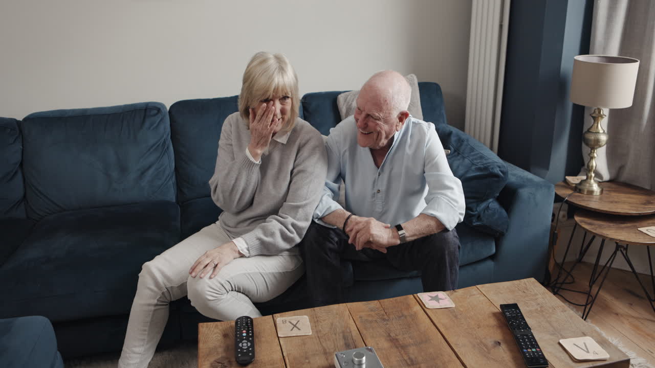 Elderly Couple Laughing and Playing Scrabble