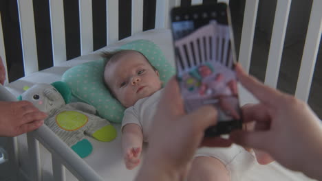 baby in crib being photographed